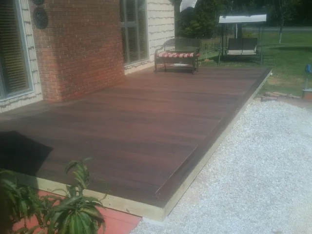 Freshly stained wood deck built against a brick home in Glendale